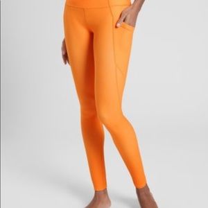 Athleta Orange Sun Salutation legging